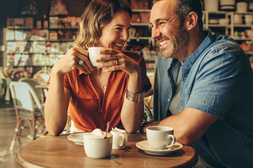 A couple laughing in a café.