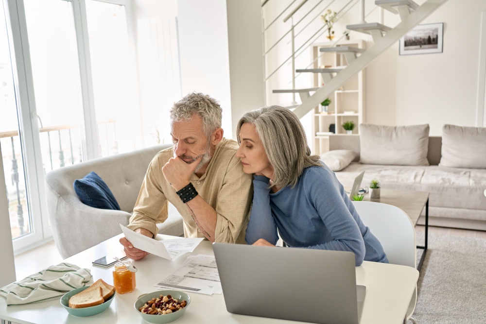 A couple looking at paperwork together in their home.