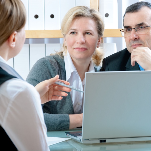 A couple talking to a financial planner.