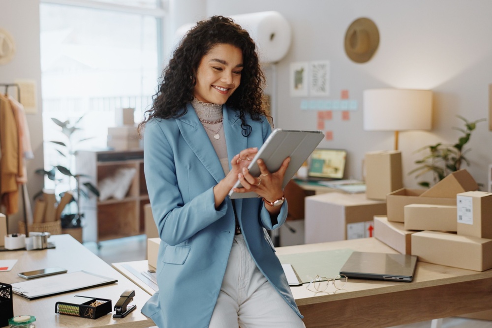 A female business owner using a tablet in an office.