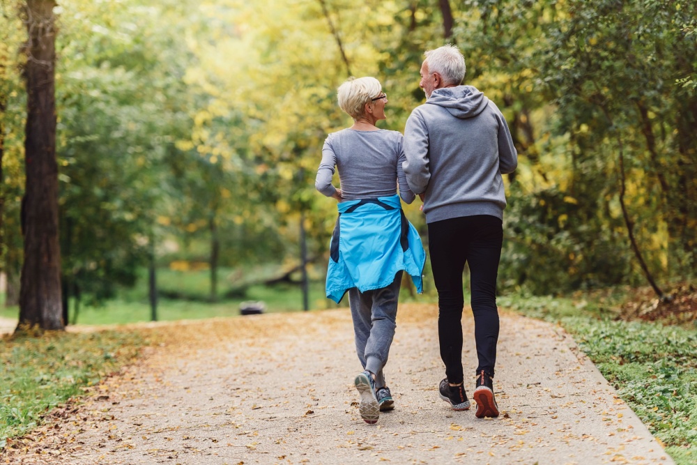 A couple jogging in a park.