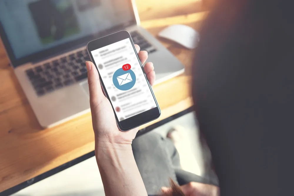 A person looking at their email on their phone.